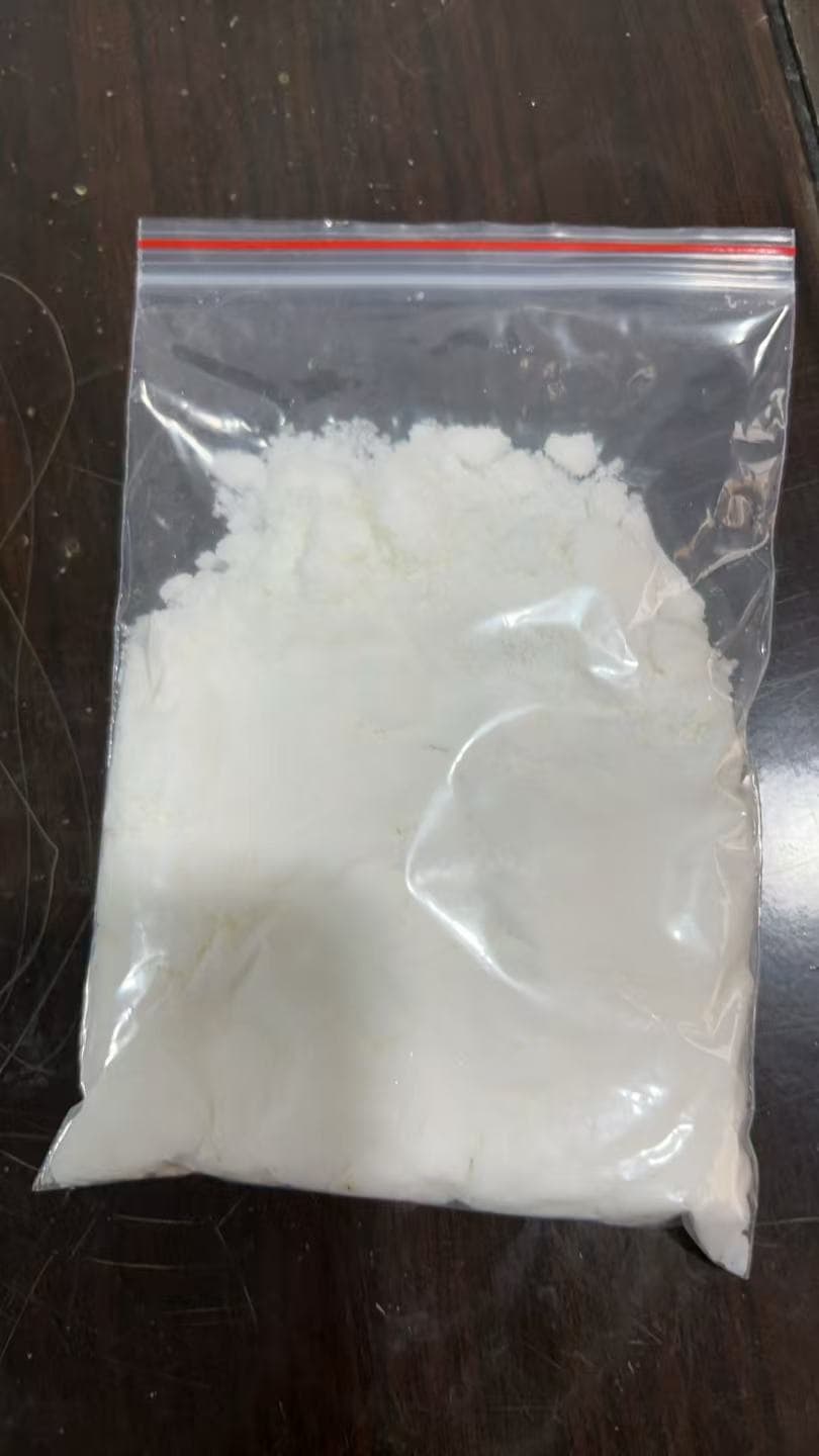 Agricultural-grade ammonium chloride: white crystalline granules in a clear sample bag