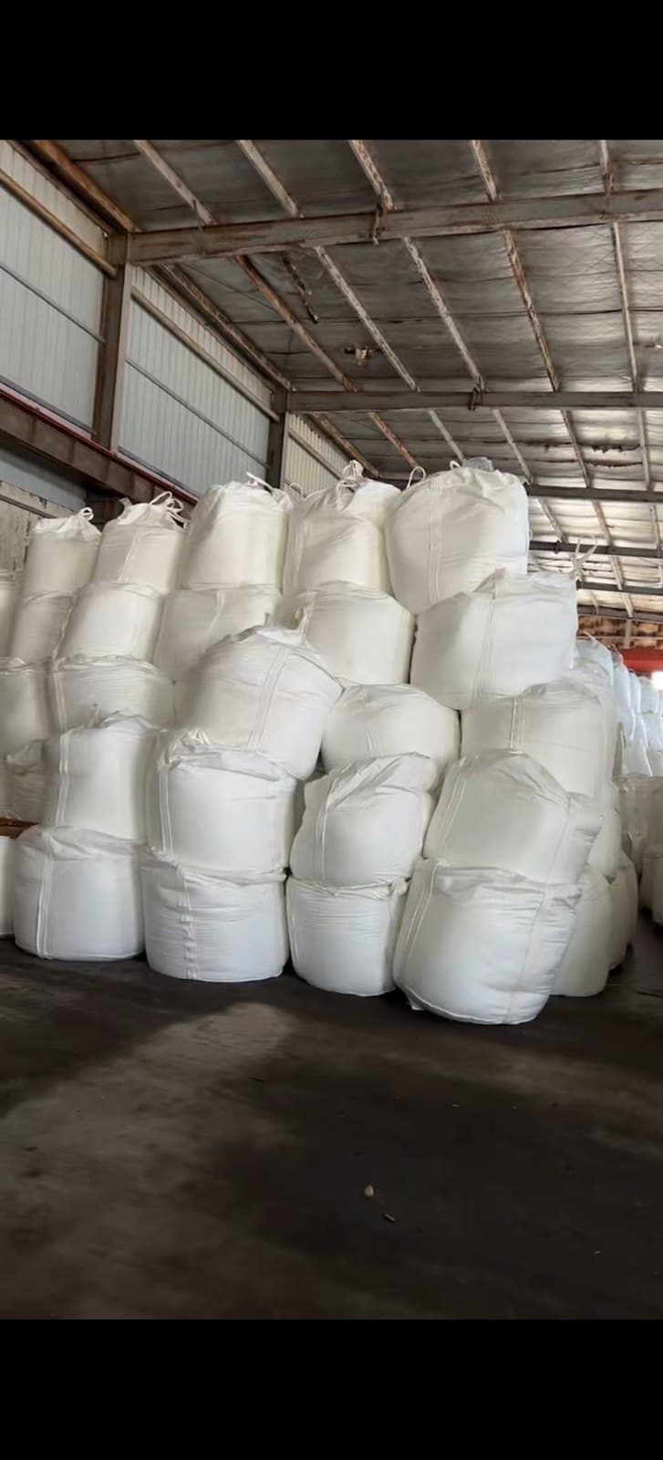 Stacked big bags of agricultural-grade ammonium chloride in the warehouse